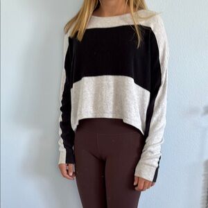 Black and Gray Colorblock Sweater with surf written in bold on the back